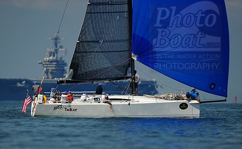 Sailboat and aircraft carrier on Chesapeake Bay